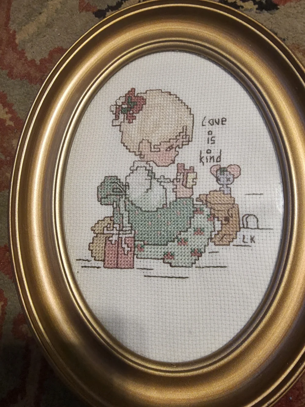 Gold Oval Framed Cross Stitch Artwork - 'Love is Kind'
